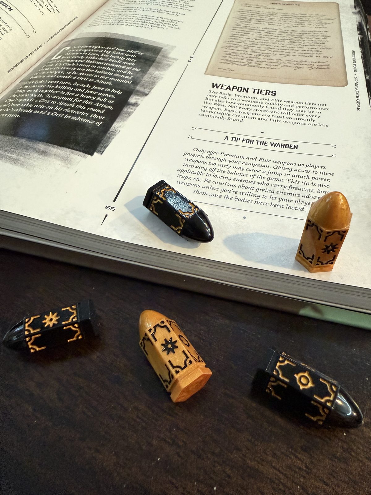 The game's bullet dice on the open rulebook